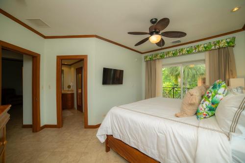 a bedroom with a large bed and a window at Veranda 3B 2 bdr Garden View in Los Suenos in Herradura