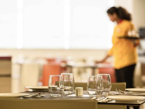 a group of wine glasses sitting on a table at ibis Bengaluru City Centre - An Accor Brand in Bengaluru