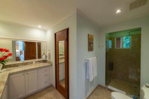 a bathroom with a shower and a sink and a toilet at Veranda 3B 2 bdr Garden View in Los Suenos in Herradura