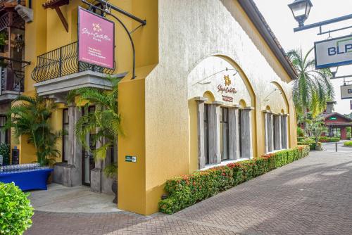a yellow building with a sign on the side of it at Veranda 3B 2 bdr Garden View in Los Suenos in Herradura