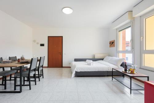a bedroom with a bed and a table and chairs at BGY Colorful Home in Grassobbio