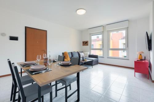 a dining room and living room with a table and chairs at BGY Colorful Home in Grassobbio