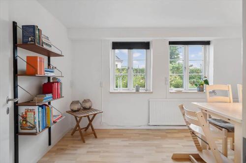 a dining room with a table and a book shelf at FY385-Nyborg-Kronprinsensgade-1-st in Nyborg