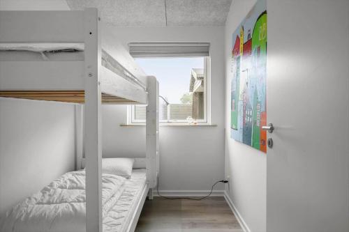 a bedroom with two bunk beds and a window at FY396-Middelfart-Siriusvej-4 in Middelfart