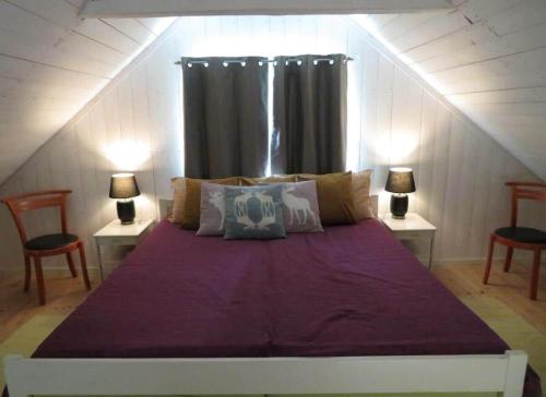 a bedroom with a large bed with purple sheets at KRO414-Loenashult-Norra-Ebboen-1 in Tvetaryd