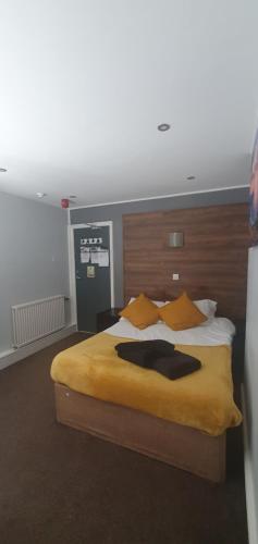 a bedroom with a large bed with a wooden headboard at South Beach Kings Promenade Hotel in Blackpool