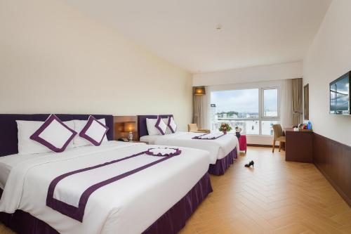 Ένα ή περισσότερα κρεβάτια σε δωμάτιο στο TTC Hotel Michelia