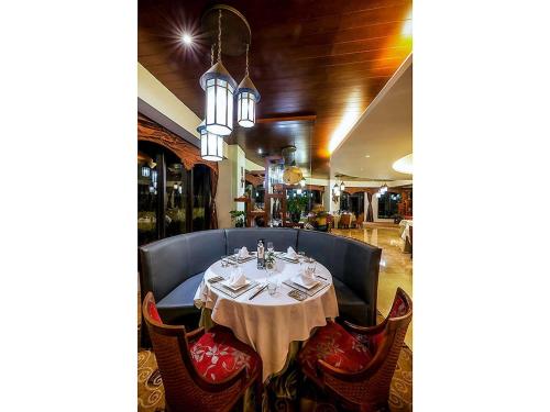 a table in a restaurant with a white table cloth at Pullman Sanya Yalong Bay Villas & Resort in Sanya