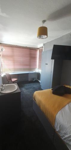 a hotel room with a bed and a sink at South Beach Kings Promenade Hotel in Blackpool