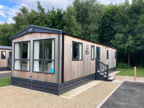 a tiny house sitting in a parking lot at Rejuven8 Rentals - Kingfisher Caravan Park - Ingoldmells in Ingoldmells