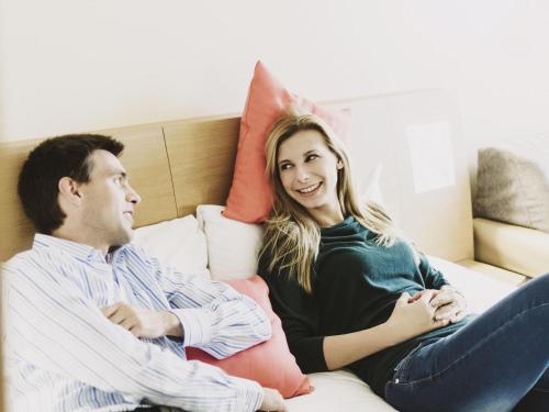 a man and a woman sitting on a couch at Novotel Liverpool Centre in Liverpool