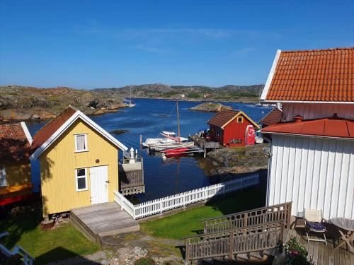 a view of a harbor with houses and a boat at BOH668-Kloevedal-Bjoerholmen-81 in Björholmen
