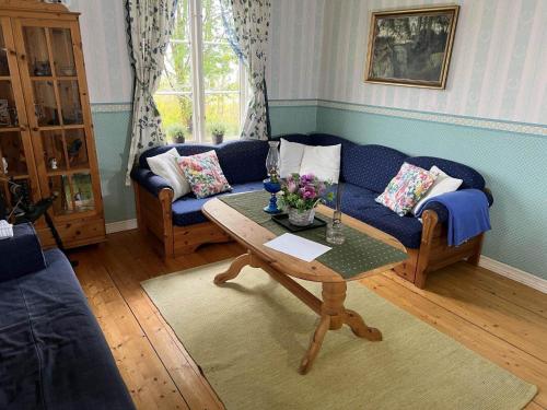 a living room with a blue couch and a table at VGO700-Dalum-Ingared-101 in Tomten