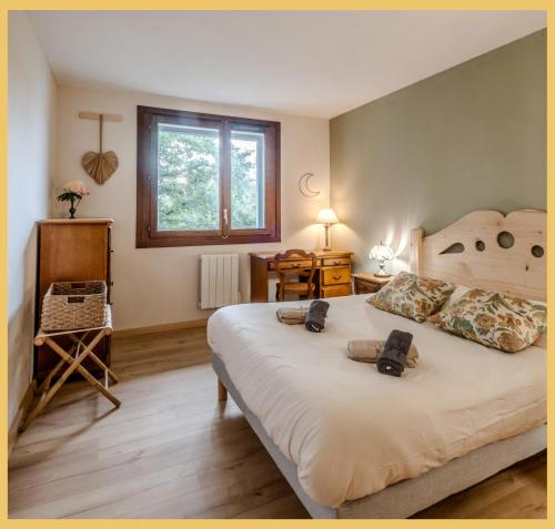 a bedroom with a large bed and a window at Chez Isabelle & Urbain I T3 I Saint-Julien in Saint-Julien-en-Genevois