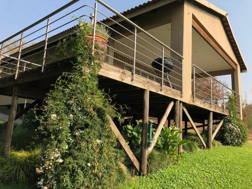 a building with a balcony with a dog on it at Hills and Dales Accommodation in Lanseria