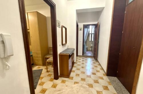 a room with a hallway with a mirror and a floor at Lavinia House in Oliveri