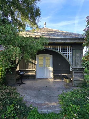 a small house with a white door and a garage at Solvang in Assens