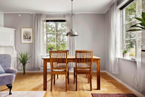 a dining room table with two chairs and a window at OGO781-Mjoelby-Norrby-Naesloesegard-1 in Mjölby