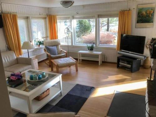 a living room with a couch and a tv at VGO765-Torestorp-Kammarholmen-1 in Torestorp