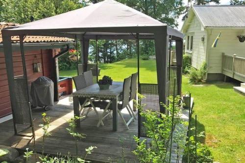a gazebo with a table and chairs on a deck at VGO765-Torestorp-Kammarholmen-1 in Torestorp
