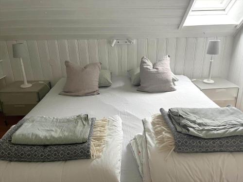 a large white bed in a room with a window at SKA711-Simrishamn-Lugnadalsvaegen-1 in Baskemölla
