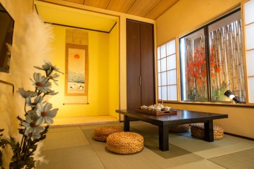 a living room with a table and a window at スカイツリーコテージ in Tokyo