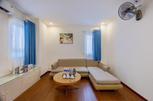 a living room with a couch and a table at A25 Hotel - 274 Đề Thám in Ho Chi Minh City