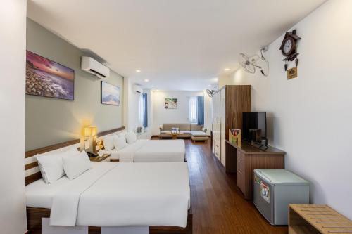 a hotel room with two beds and a couch at A25 Hotel - 274 Đề Thám in Ho Chi Minh City