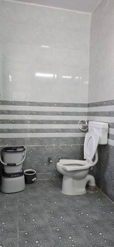 two toilets are sitting next to a wall at Vidhilekh hotel in Dwarka
