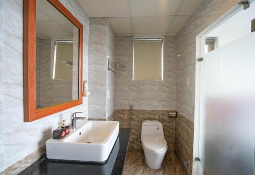 a bathroom with a sink and a toilet at Quoc Cuong Hotel & Apartment Danang by Haviland in Da Nang