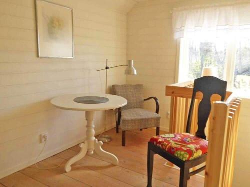 a room with a table and a chair and a desk at KRO732-Urshult-Berg-Faekten in Urshult