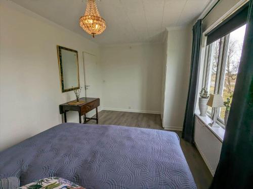a bedroom with a purple bed and a window at OGO780-Mjoelby-Norrby-Naesloesegard-1 in Mjölby