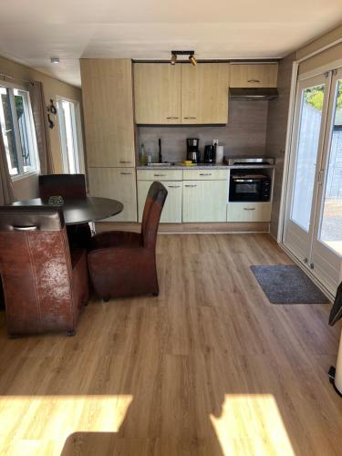 a kitchen with a table and chairs in a room at Familiechalet Vechtdal in Diffelen
