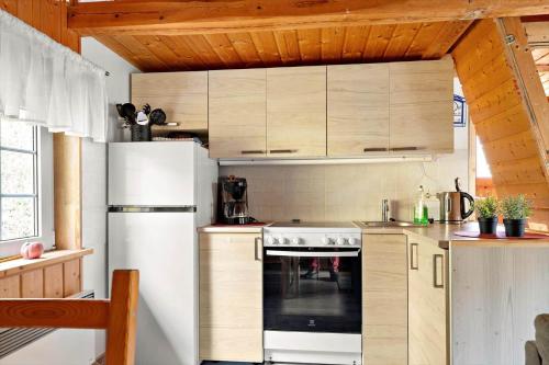 a kitchen with a white refrigerator and a stove at VGO786-Hacksvik-Hacksvik-1 in Bygärde