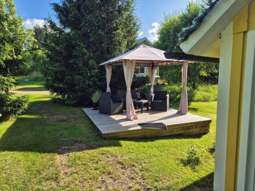 a gazebo with a table and chairs on a deck at VGO786-Hacksvik-Hacksvik-1 in Bygärde