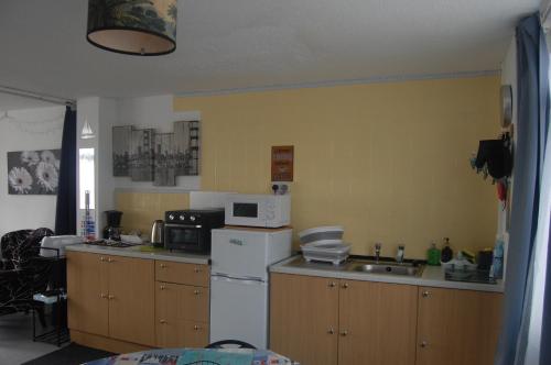 a kitchen with a white refrigerator and a sink at Dawlish Warren Welcome family holiday park South Devon Willow villa Welcome2Warren in Dawlish Warren