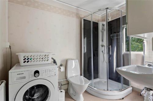a bathroom with a washing machine and a sink at KRO047-Urshult-Vaesterbotorp-Bosgard in Urshult