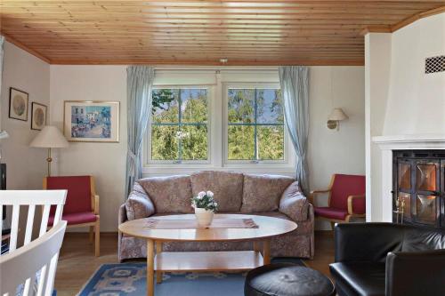 a living room with a couch and a table at KRO043-Urshult-Vaesterbotorp-Bosgard in Urshult
