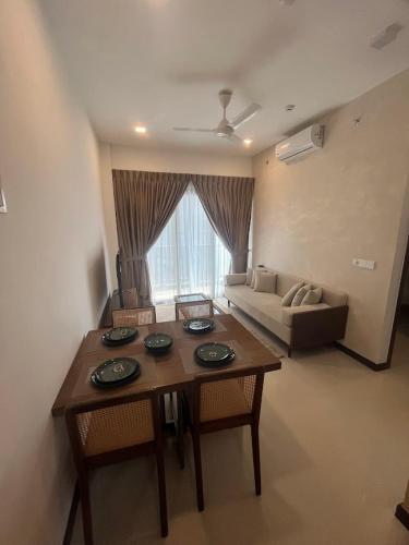 a living room with a table and a couch at Colombo, Trizen Luxury Apartments, Sri Lanka in Colombo