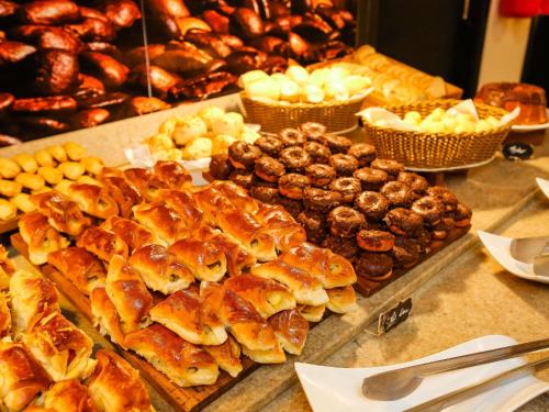 a buffet of pastries and other baked goods on a counter at ibis Copacabana Posto 2 in Rio de Janeiro