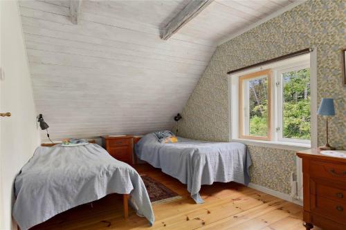 a bedroom with two beds and a window at KRO384-Urshult-Vaesterbotorp-Bosgard in Urshult