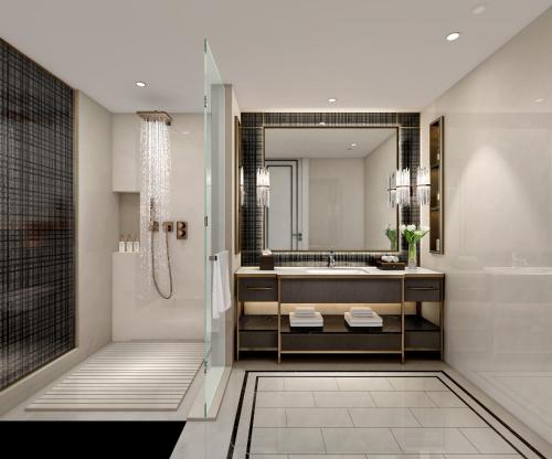 a bathroom with a shower and a tub and a sink at Pullman Beijing South in Daxing