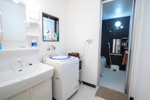 a bathroom with a sink and a washing machine at スカイツリーコテージ in Tokyo