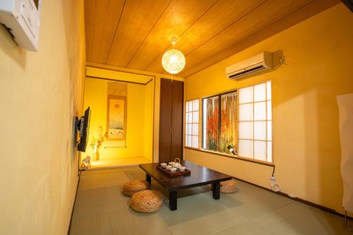 a living room with a table and a window at スカイツリーコテージ in Tokyo