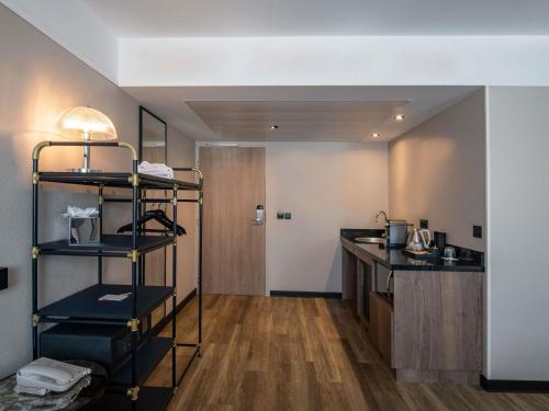 a room with a kitchen and a room with a counter at Novotel Suites Nice Airport in Nice
