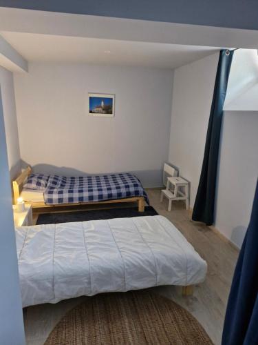 a bedroom with two beds in a room at Quiet duplex in historic town centre in Perros-Guirec