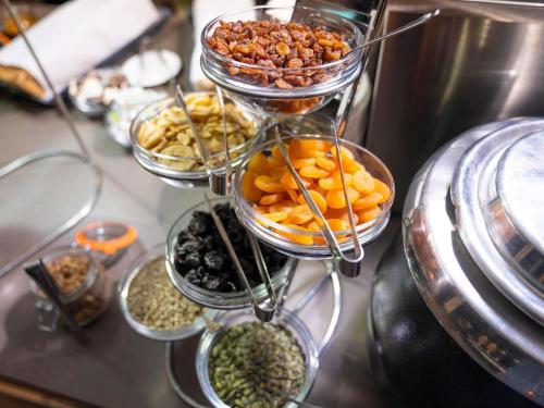 a three tiered tower filled with different types of food at Novotel Edinburgh Park in Edinburgh