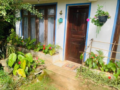 a front door of a house with flowers and plants at Shalom place in Bandarawela