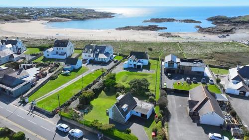 an aerial view of a house with a beach at Beach Access-Ynys Cartref-4-Bed in Trearddur