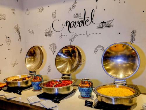 a buffet with three different types of food in bowls at Novotel RJ Santos Dumont in Rio de Janeiro